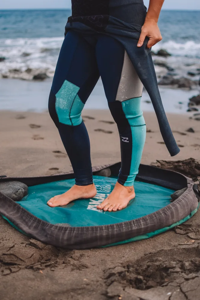Standing on a changing mat while removing my wetsuit