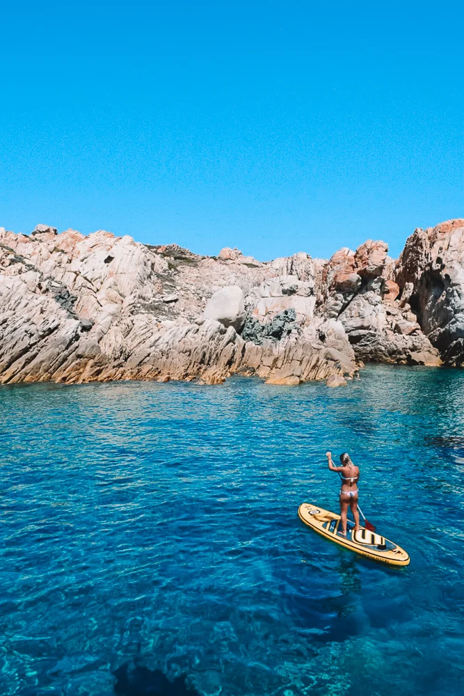 Greta doing paddle boarding in Sardinia, Italy