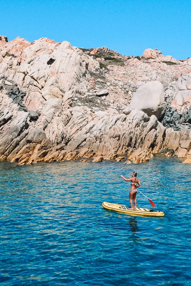 Greta using an inflatable paddle board in Sardinia, Italy